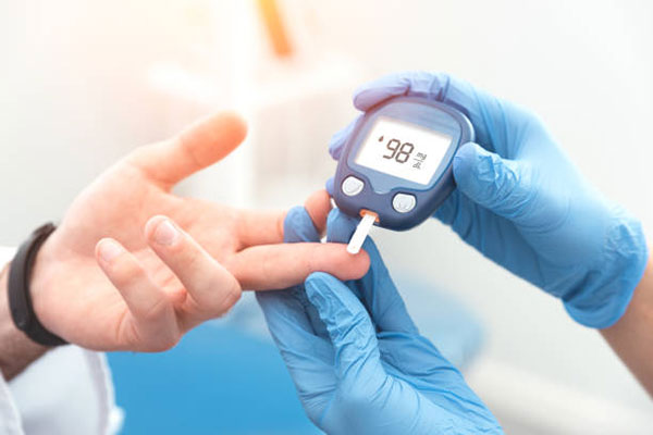 A person is being checked for blood glucose level